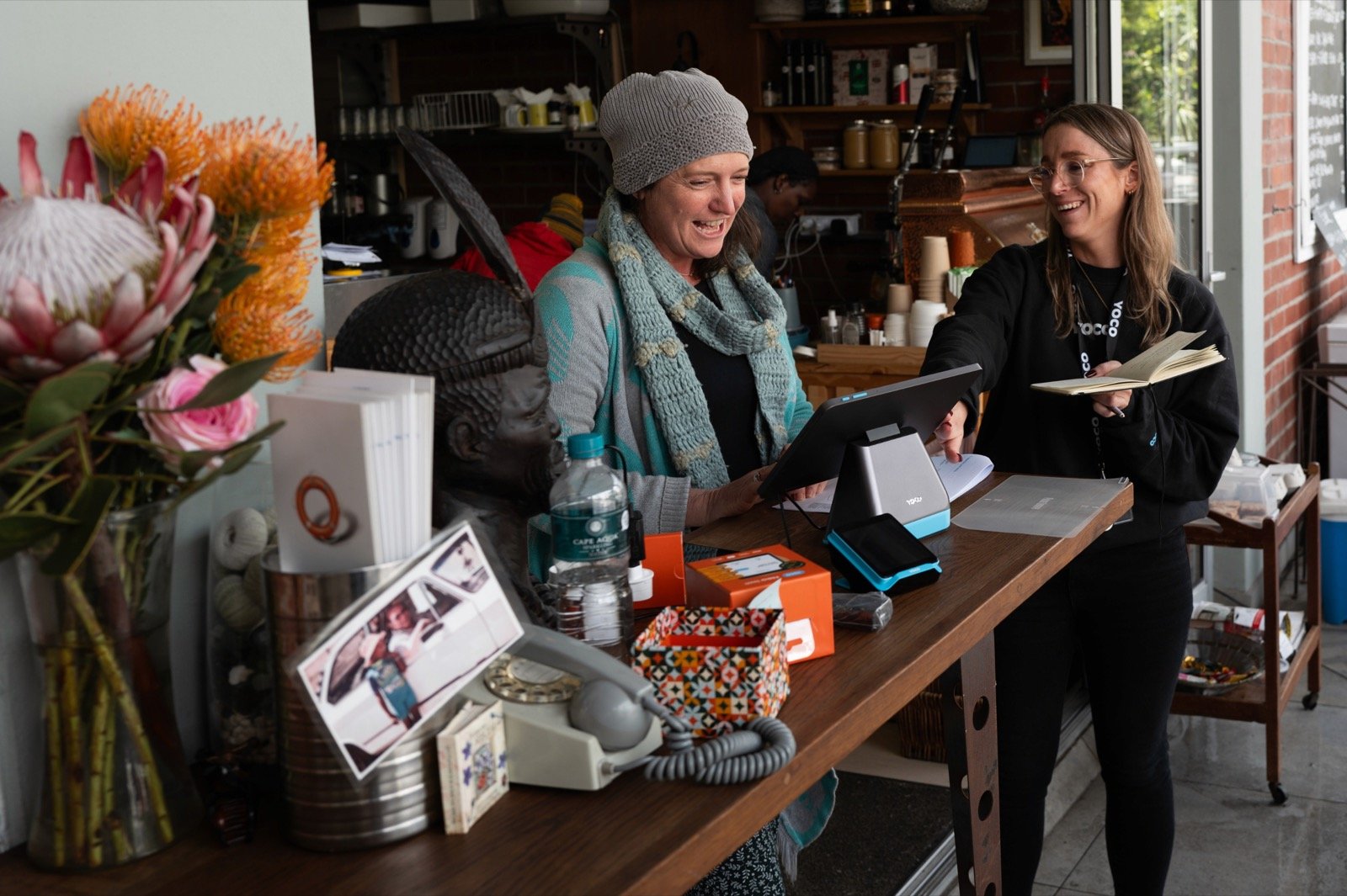 A Yoco team member helping an independent merchant set up a Yoco point-of-sale system